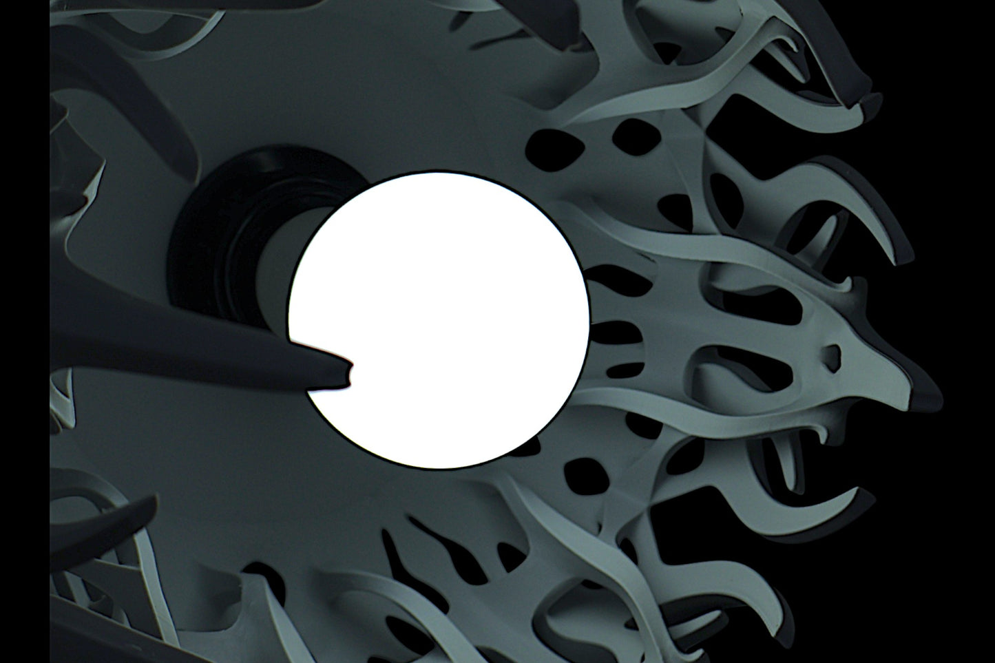 Pendant lamp – 3D printed with light gray shell and flame-inspired cutouts, glowing bulb visible through perforations
