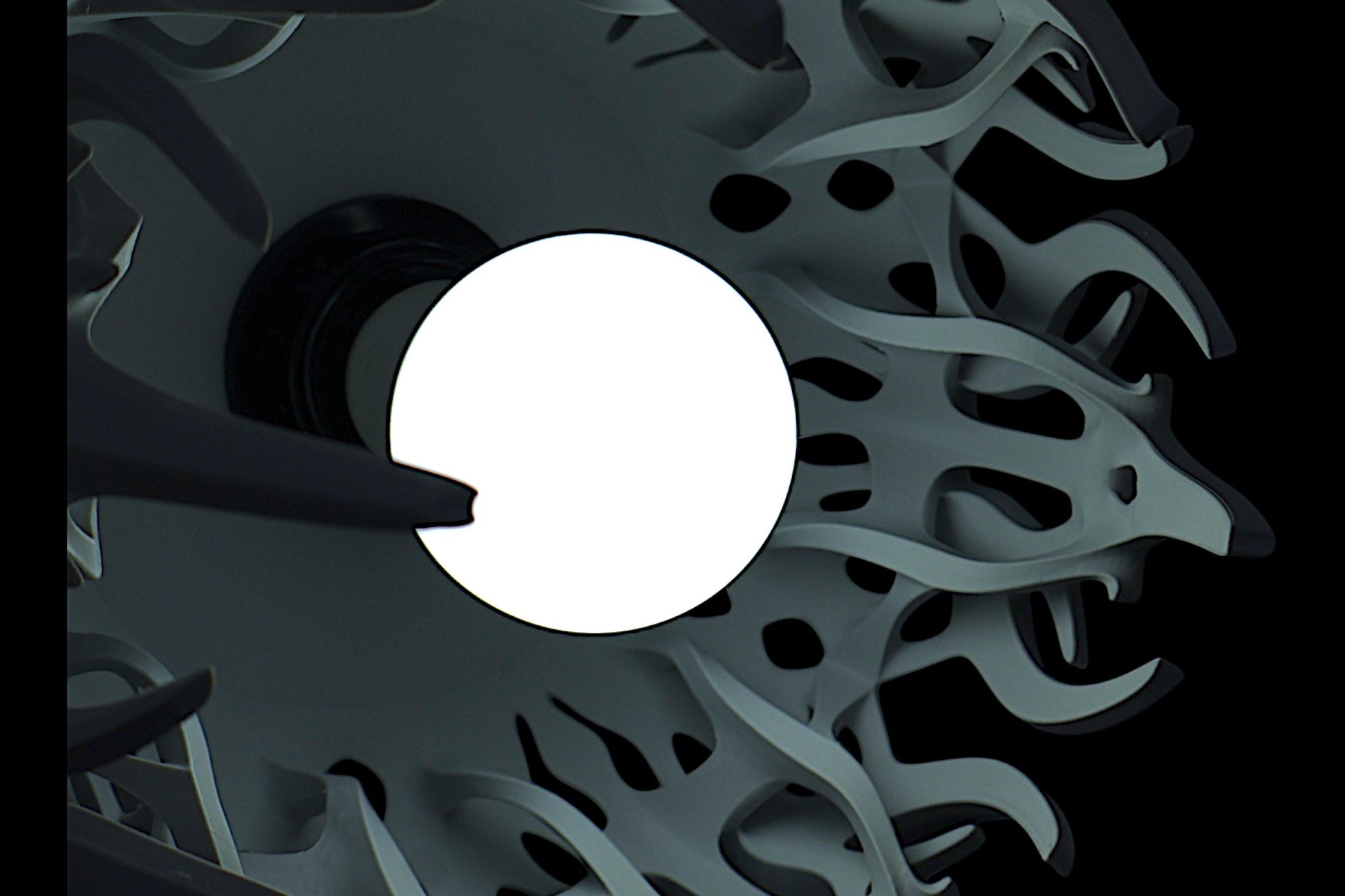 Pendant lamp – 3D printed with light gray shell and flame-inspired cutouts, glowing bulb visible through perforations
