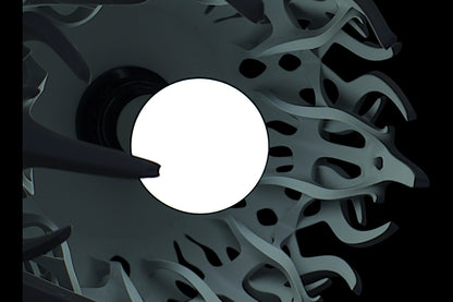 Pendant lamp – 3D printed with light gray shell and flame-inspired cutouts, glowing bulb visible through perforations
