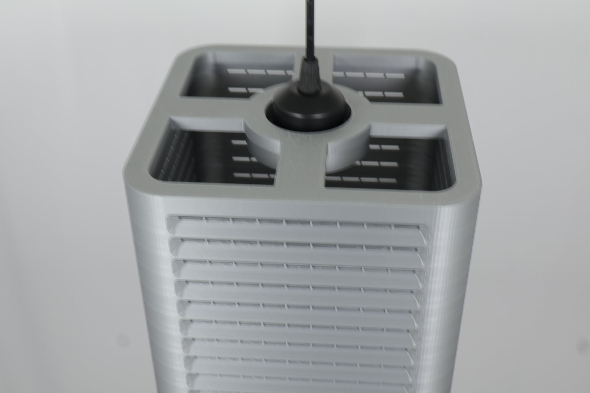 Coro pendant lamp – 3D printed with compact rectangular frame, centered lens and ribbed top and bottom panels