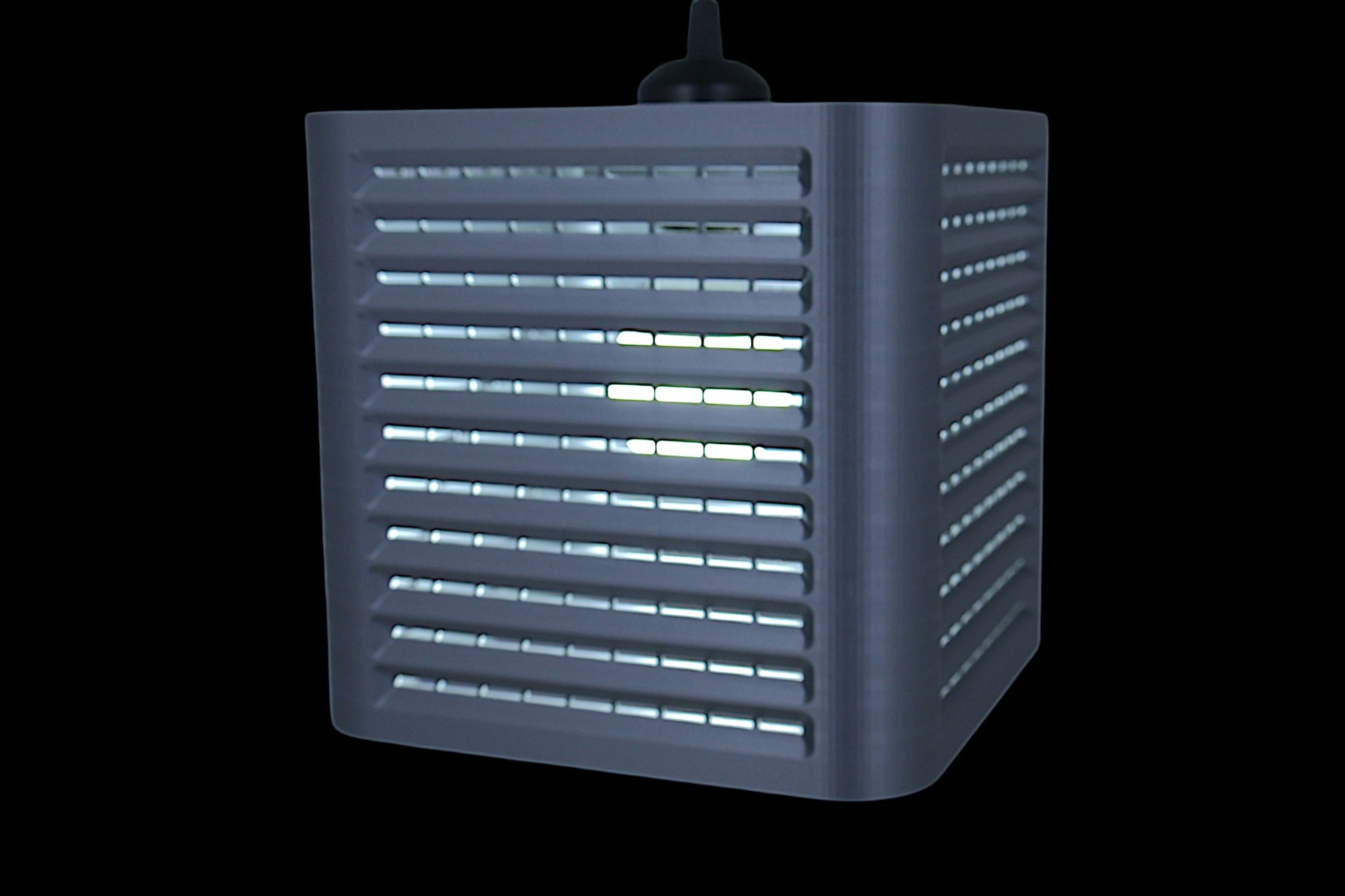 Coro pendant lamp – 3D printed with cube-shaped housing and horizontal slats, internal bulb emits soft white glow
