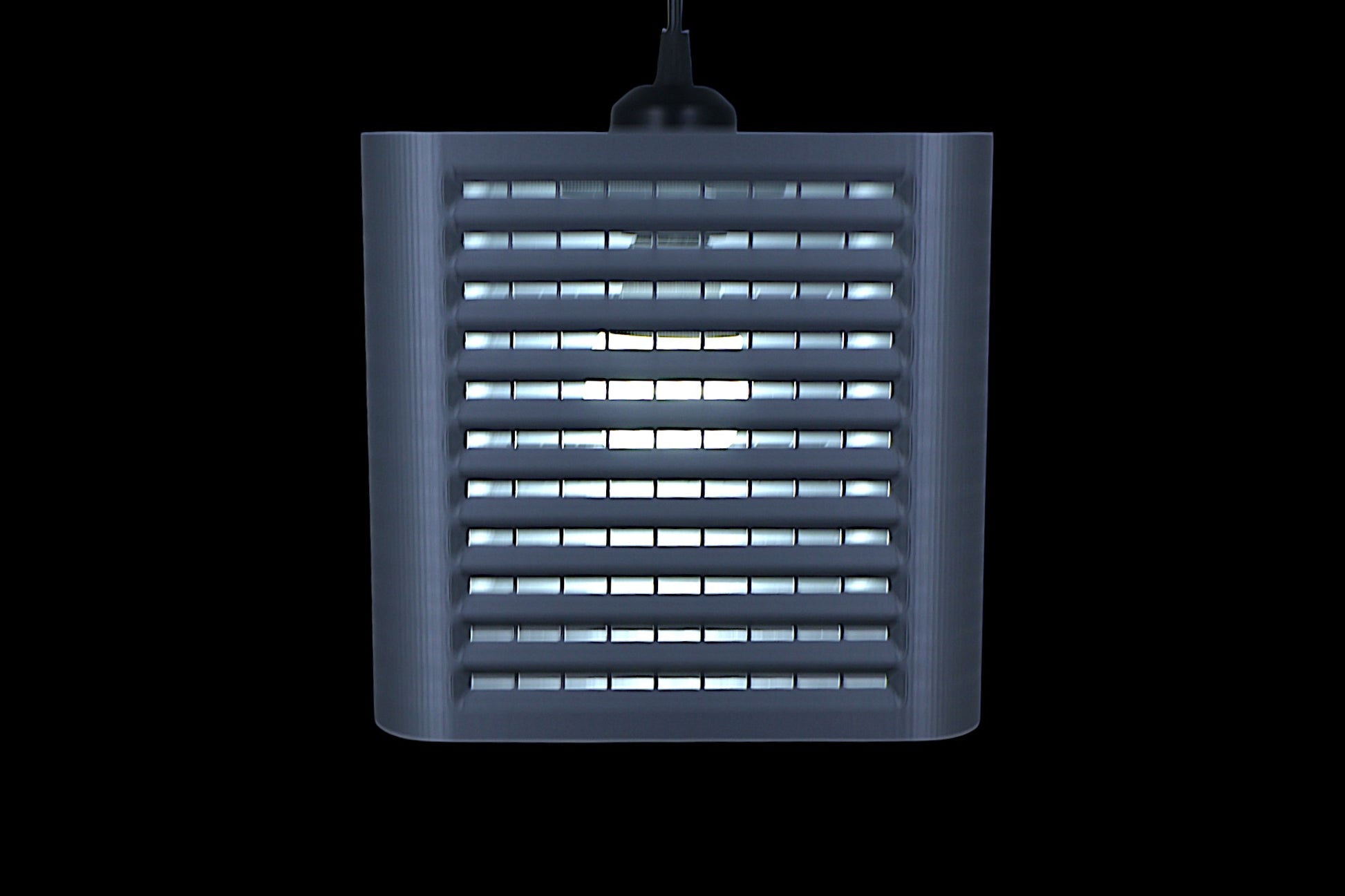 Coro pendant lamp – 3D printed with cube-shaped housing and horizontal slats, internal bulb emits soft white glow
