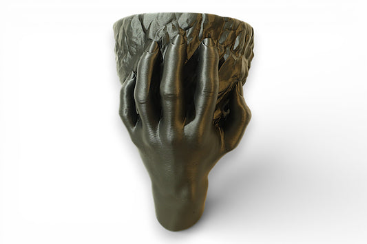 Wall planter with a sculpted hand gripping a rough rock-shaped vessel, bold and anatomical.