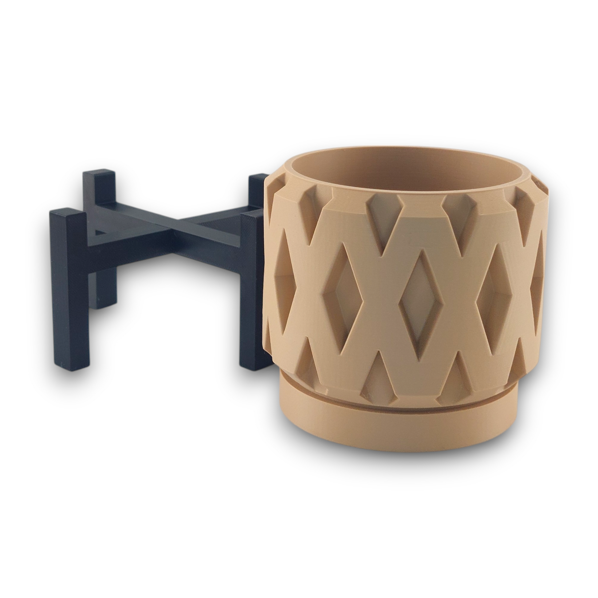 A beige cylindrical container with a diamond-patterned surface is placed next to a black stand. The stand appears to be designed to hold the container, elevating it above the ground. This combination showcases a modern and geometric design, making it a stylish piece for home decor.