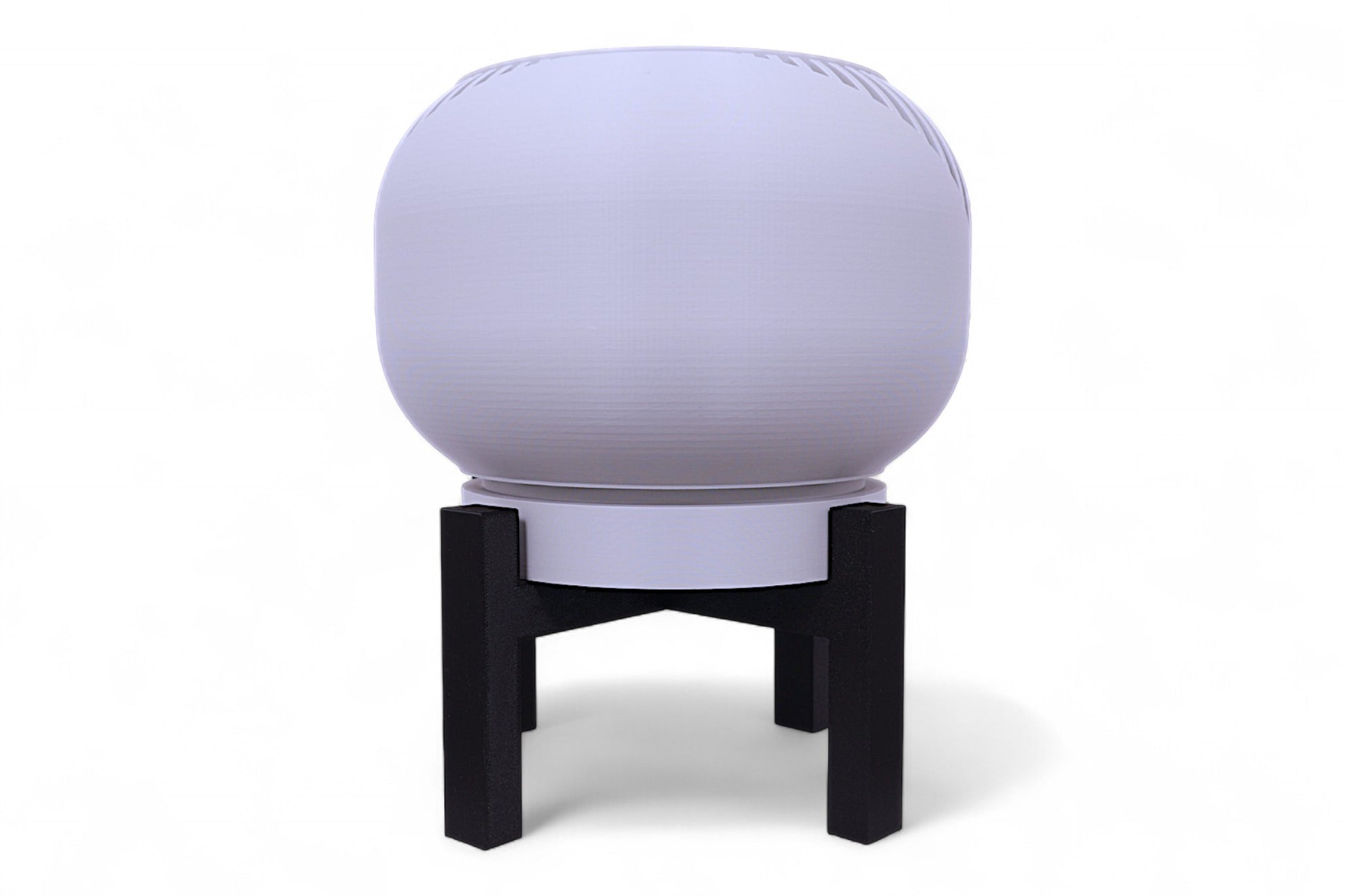 Gray planter with diagonal slatted texture next to black four-legged stand