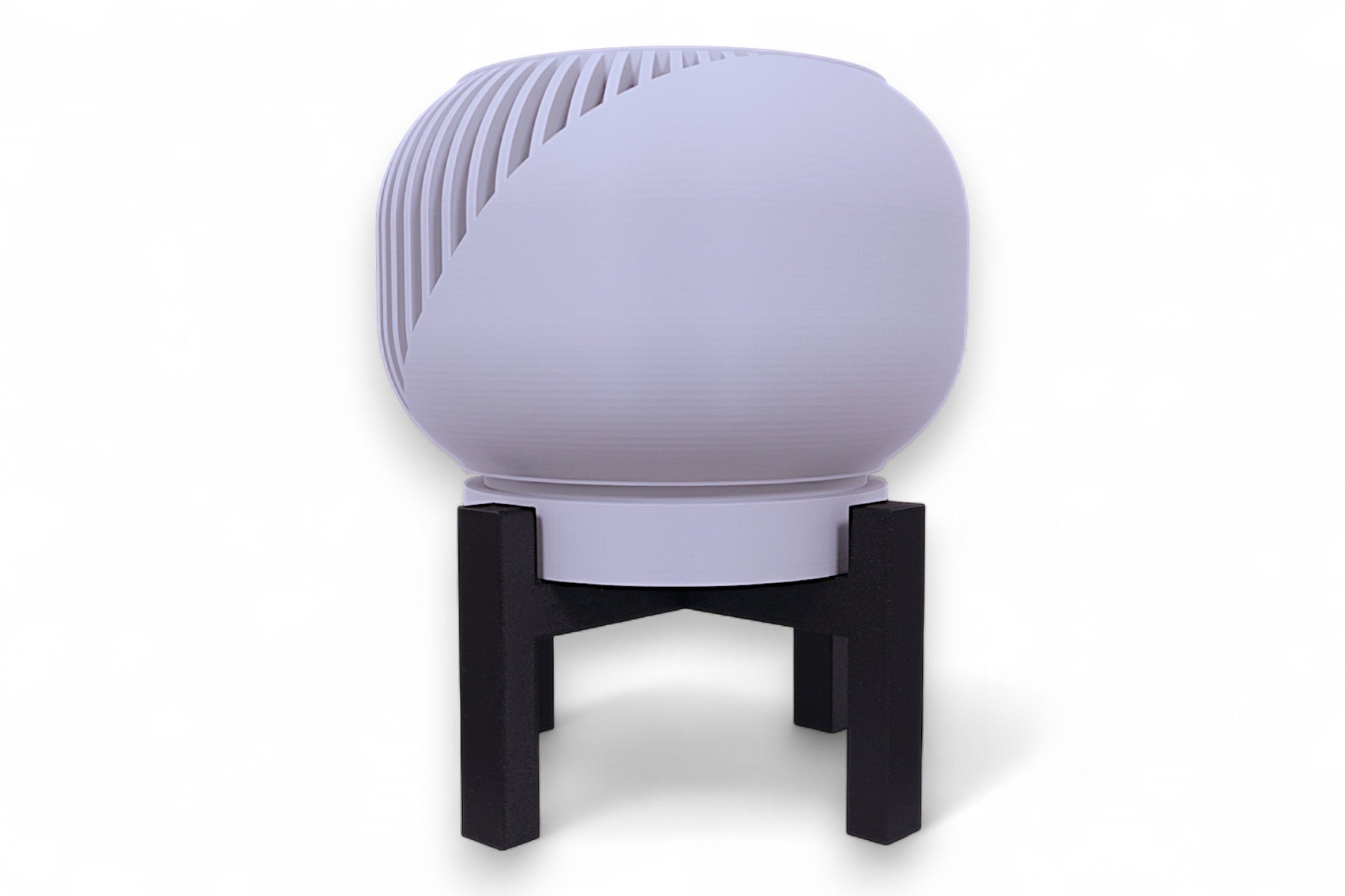 Gray planter with diagonal slatted texture next to black four-legged stand