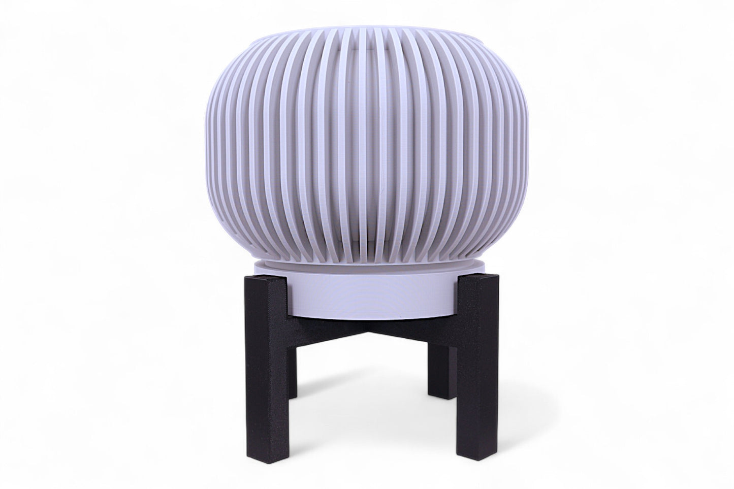 Gray planter with smooth rounded body on black four-legged stand