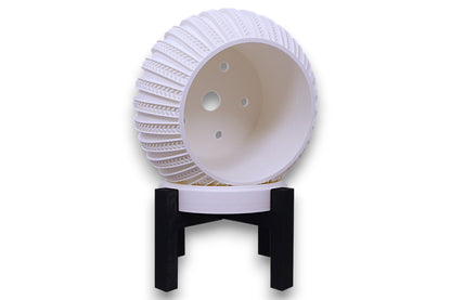 White sculptural planter with gold-accented lattice texture on black stand