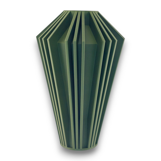 A green, geometric vase with a faceted design. The vase has a unique, angular shape with multiple vertical ridges and grooves, giving it a modern and sculptural appearance. The vase tapers slightly towards the bottom and has a flat top opening.