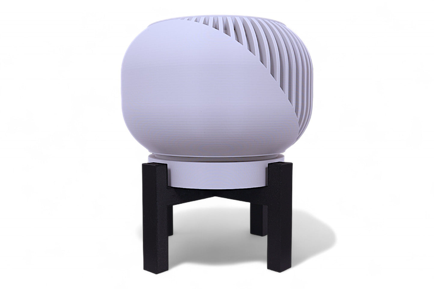 Gray planter with smooth rounded body on black four-legged stand