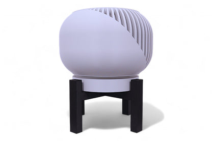 Gray planter with smooth rounded body on black four-legged stand