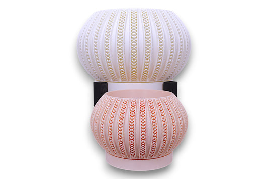 Stacked white and blush pink planters with triangular cutouts separated by black support